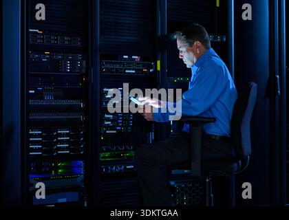 Man using digital tablet in data center Stock Photo