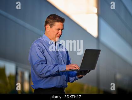 Man working on laptop outdoors Stock Photo
