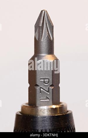 PZ1 Pozidriv screwdriver bit close-up showing cross-head tip and hexagonal shank in drill chuck on white background Stock Photo