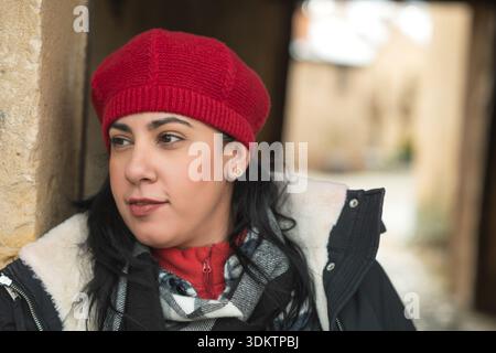 Young adult woman wearing a red beret and warm winter clothing outdoor Stock Photo