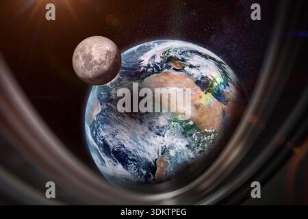 Moon, Earth and solar eclipse seen through a spaceship window. The Moon shadow falls on Earth. This image elements furnished by NASA. Stock Photo