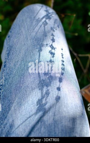 Jean Leg Art with Shadows and Sunlight in Outdoors Close Up Stock Photo