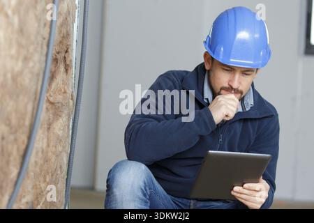 a builder working on computer tablet Stock Photo