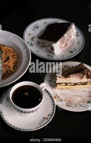 Japanese Cafe Set with Spaghetti, Chocolate Cake, Tiramisu, and Coffee on a Dark Table Stock Photo