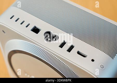 Close-up of back panel of compact desktop computer with power input, USB ports, network connector and ventilation grille Stock Photo