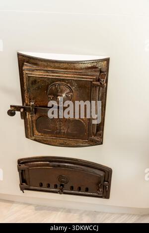 Closed door of old vintage fireplace chimney in historic building interior living room Stock Photo