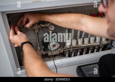 Technician working on home heating system maintenance Stock Photo