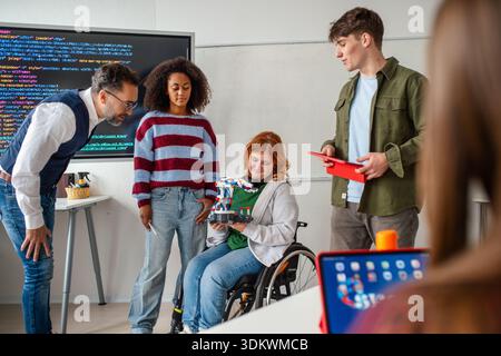 Inclusive student team presenting technology project in class. Stock Photo