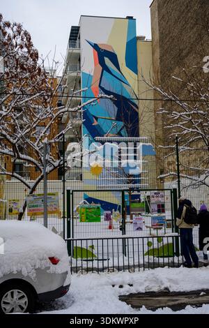 Mural of a blue and orange bird painted on the side of a building, Budapest, Hungary, The artwork is painted in a geometric, low-poly style, predomina Stock Photo