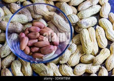 Assorted Peanuts In Shell And Peanuts In A Glass Bowl On Wooden Table Stock Photo