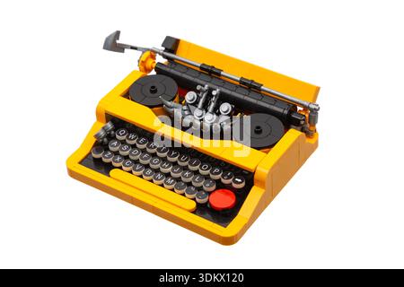 Yellow and black toy construction block typewriter model isolated on white background. Stock Photo