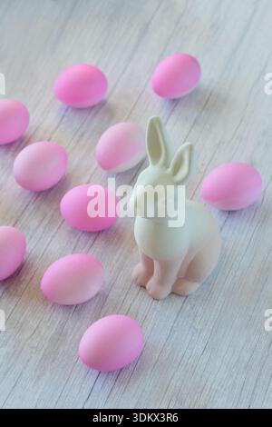 Ceramic Easter bunny and eggs dyed pink Stock Photo