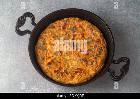 This delicious-looking vegetable omelet is prepared with eggs and various herbs. Stock Photo