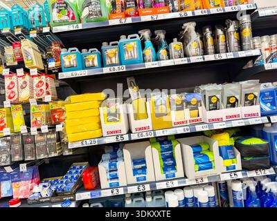 A vibrant display of various car cleaning products arranged on shelves in a store, showcasing different brands and packaging styles Stock Photo