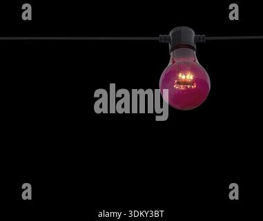 Red color lightbulb on string isolated on black Stock Photo