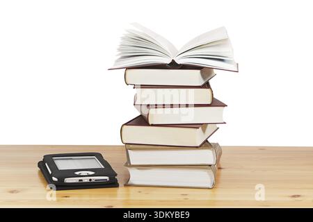 A pile of books and e-book on wood table against a white background Stock Photo
