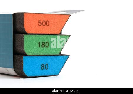 Three grinding sponges of different grain sizes, neatly folded in original packaging. Ends with markings are visible Stock Photo