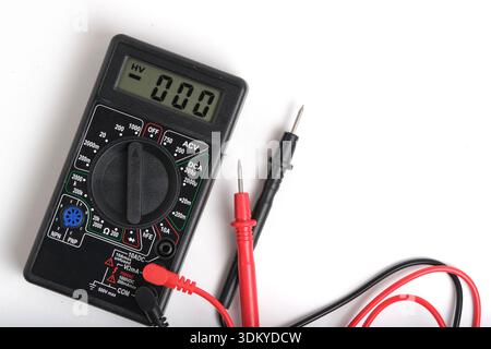 Digital multimeter with measuring leads isolated on light background. Close up standard electrical testing tool for home and professional use Stock Photo