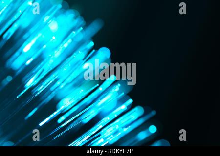 Blue optical fiber strands for telecommunication technology. Abstract digital background with bokeh. 5G network and cloud computing visualization Stock Photo