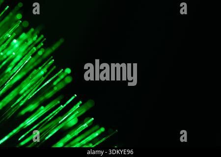 Green fiber optic lights background. Concept of eco friendly technology, digital matrix, and secure data transmission. Bright neon glowing lines Stock Photo