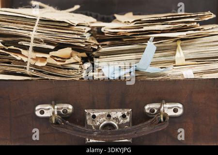 Bunches of paper mails of 20 century in the vintage suitcase, closeup Stock Photo