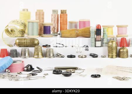 Various vintage accessories and tools for hand sewing on white stairs Stock Photo