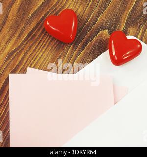 Opened envelope with the red heart and a pink paper for your text Stock Photo