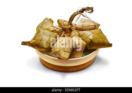 Ketupat is a traditional Indonesian food made from rice wrapped in woven young coconut leaves, in the form of a rectangular bag that is boiled. Stock Photo