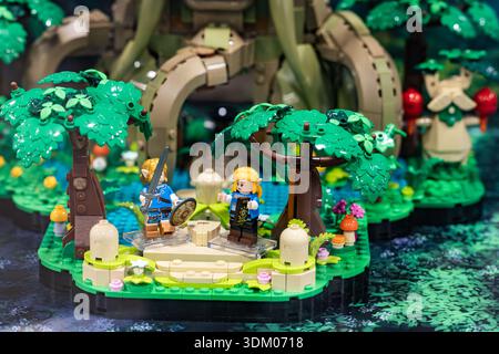 Toy figurines made of plastic construction blocks in a fantasy forest scene, miniature display with trees, characters Stock Photo