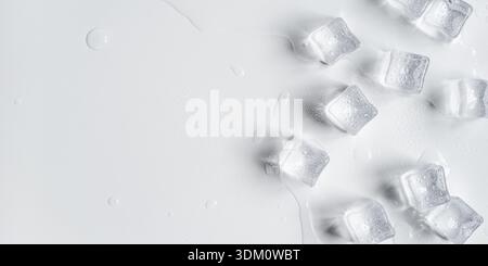 Melting ice cubes in a splash of water on a white background Stock Photo