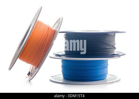Plastic filament on a spool for 3D printer isolated on a white background. Stock Photo