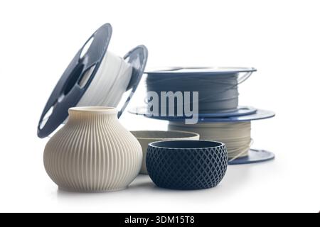 Plastic filament for 3D printer and printed products isolated on a white background. Stock Photo