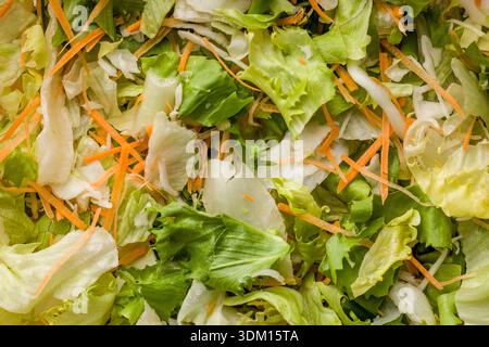 Mix of fresh green salad with carrot. Top view. Stock Photo