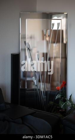 Tall Stack Of Sealed Cardboard Boxes Standing In An Empty Office Room With Window Light And Blurred Foreground Elements Suggesting Storage Or Office M Stock Photo