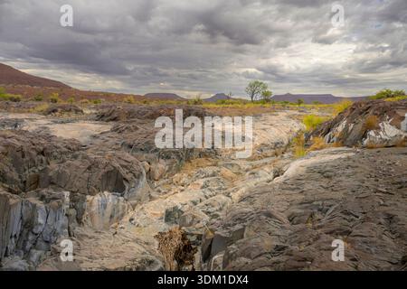 Eroded rock from a water stream in mountain desert ladscape, Damaraland, Namibia. Stock Photo
