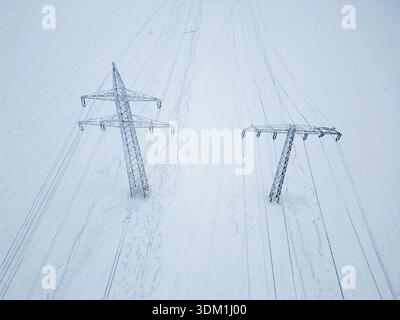 03 February 2026, Saxony-Anhalt, Harz: View of frozen power lines in Hüttenrode. The permafrost in the Harz Mountains has led to icy cables holding high-voltage power lines, making them a safety risk. Because the cables could break, the road between Hüttenrode and Almsfeld will be closed for at least a week, according to the Ministry of Infrastructure in Magdeburg. According to the information, traffic will be diverted via Blankenburg. The responsible grid operator Avacon took the overhead line out of operation as a precautionary measure for safety reasons. The ice cover was too strong and the Stock Photo