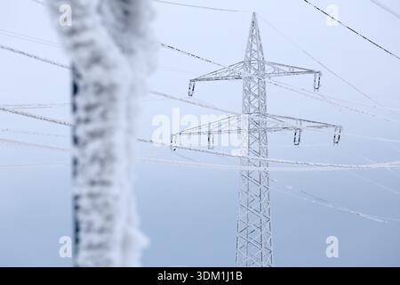 03 February 2026, Saxony-Anhalt, Harz: View of frozen power lines in Hüttenrode. The permafrost in the Harz Mountains has led to icy cables holding high-voltage power lines, making them a safety risk. Because the cables could break, the road between Hüttenrode and Almsfeld will be closed for at least a week, according to the Ministry of Infrastructure in Magdeburg. According to the information, traffic will be diverted via Blankenburg. The responsible grid operator Avacon took the overhead line out of operation as a precautionary measure for safety reasons. The ice cover was too strong and the Stock Photo