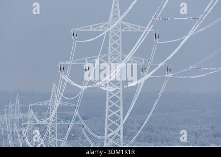 dpatop - 03 February 2026, Saxony-Anhalt, Harz: View of frozen power lines in Hüttenrode. The permafrost in the Harz Mountains has led to icy cables holding high-voltage power lines, making them a safety risk. Because the cables could break, the road between Hüttenrode and Almsfeld will be closed for at least a week, according to the Ministry of Infrastructure in Magdeburg. According to the information, traffic will be diverted via Blankenburg. The responsible grid operator Avacon took the overhead line out of operation as a precautionary measure for safety reasons. The ice cover was too stron Stock Photo