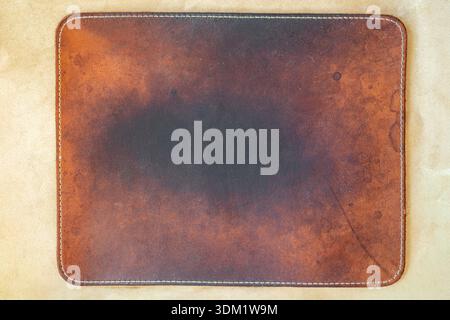 Brown leather background, grunge noise texture. Old spotted brown leather texture with stitching on light background, material surface for design Stock Photo