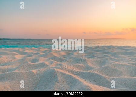 Stunning tropical beach golden sunset soft sand shore low angle warm glow turquoise water closeup serene dreamy summer texture background wallpaper Stock Photo