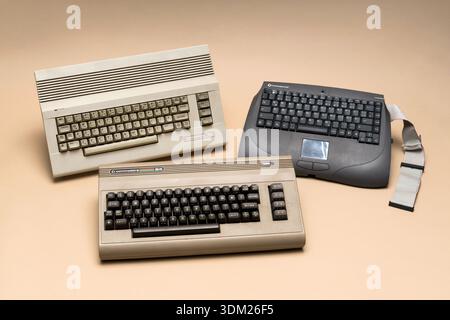 Pavia, Lombardy, Italy - December 8, 2024: From left to right: the Commodore 64 C and the post-bankruptcy Commodore 64 Web. Below: the classic Commodo Stock Photo