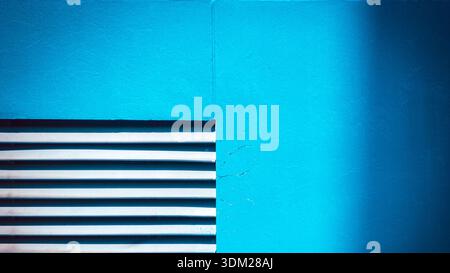 Abstract minimalist architecture background featuring a vibrant blue wall with horizontal white ventilation lines and a clean geometric texture for de Stock Photo