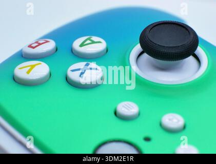 Macro close-up of colorful game controller buttons and analog joystick. Modern gaming technology background for esports, videogames, entertainment and Stock Photo