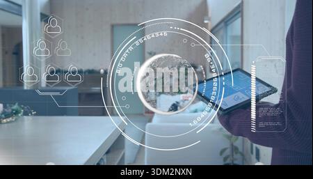 Projecting AR globe floating over open office, presenter standing holding tablet in dark sweater Stock Photo
