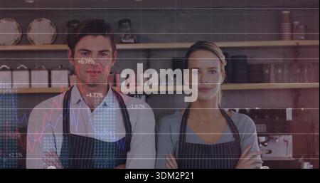 Standing two cafe partners crossing arms behind counter at coffee shop, with striped aprons, charts Stock Photo