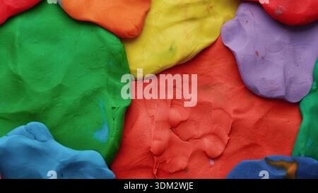 A background texture made out of multicolored play clay. Close up. Stock Photo