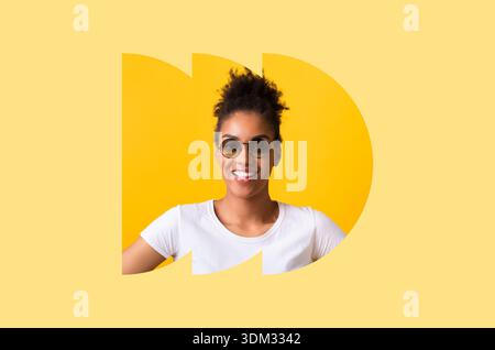 Woman Wearing Sunglasses Stands Against Yellow Background in Creative Collage Design Stock Photo
