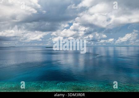 Aerial ocean view deep blue sea calm water surface sky clouds idyllic nature outdoors background copy space wallpaper Stock Photo