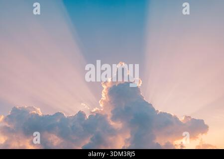 Sunset sky rays beams idyllic sunrise clouds dramatic heaven light celestial beauty hope spiritual nature landscape bright morning glow Stock Photo