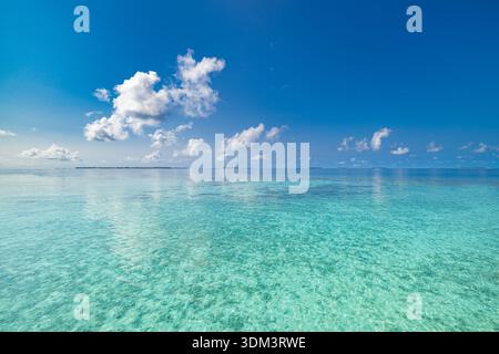 Breathtaking sunny ocean view relaxing calm water scenic horizon bright blue sky fluffy white clouds tropical sea paradise summer vacation Stock Photo